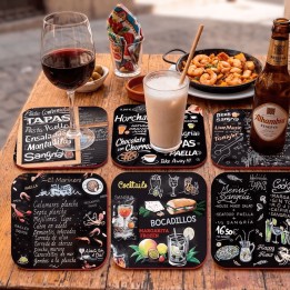 Tapas blackboard coasters on the table, with tapas, sangria and cocktails