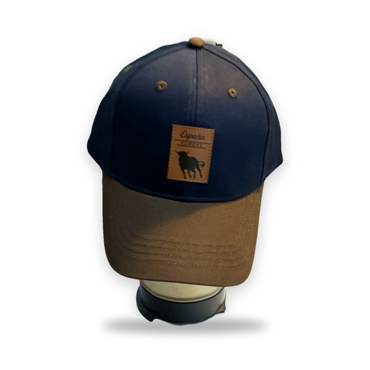Gorra Robin Ruth azul marino con visera marrón y parche de piel con toro