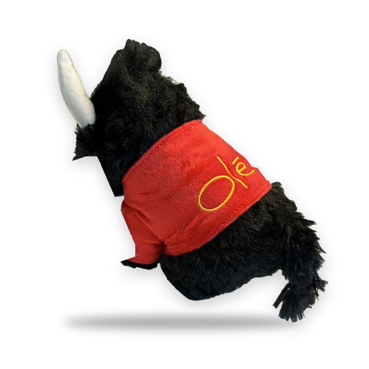Black plush bull with a red cape and the word Olé