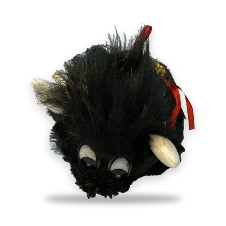 Toro de peluche negro con capa roja y la palabra Olé