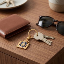 Gold Spanish National Police keyring with keys on a hall table