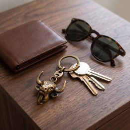 Llavero taurino de metal color cobre con llaves, cartera y gafas