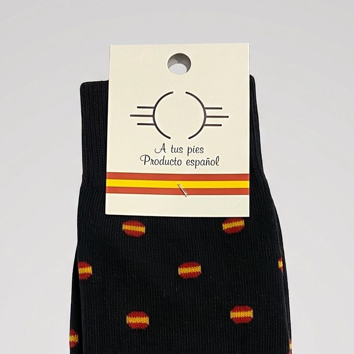 Close-up of the label and pattern of the black Spanish flag socks