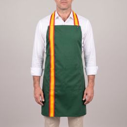 Man wearing the green kitchen bib apron with Spanish flag strap